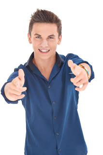 Teen holding two thumbs up showing off his smile with braces.